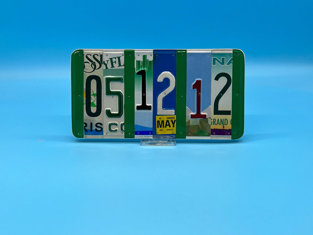 Collection of license plates 05 12 12 with various text and colors on a blue background