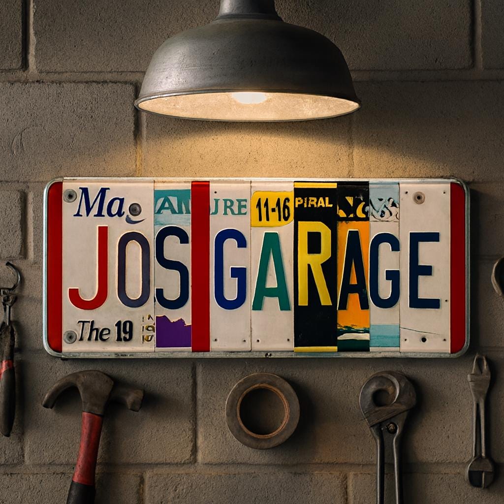 Personalized License Plate Sign: JOS GARAGE hanging on a cement wall in a workshop