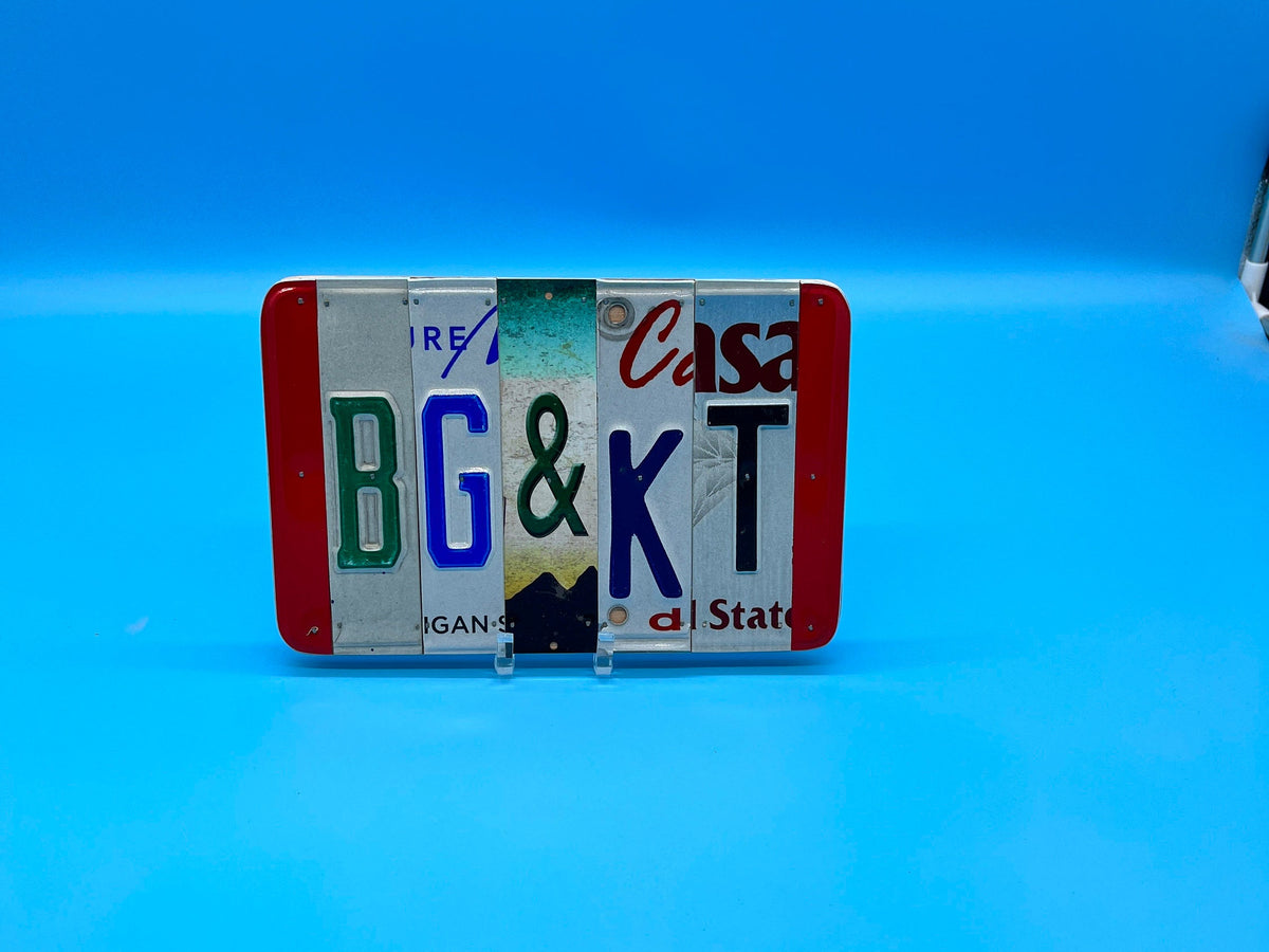 Decorative license plate sign with text BG&KT. The sign is on a blue background
