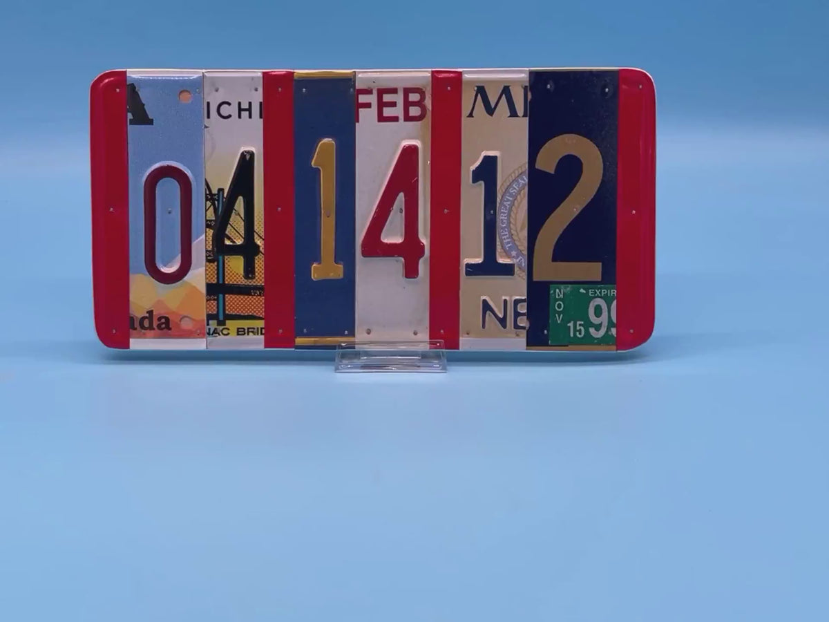 A rectangular decorative wall piece made from  license plates arranged side by side to spell out 04 14 12.